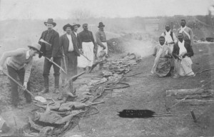 Texas Men with an open-pit barbecue
